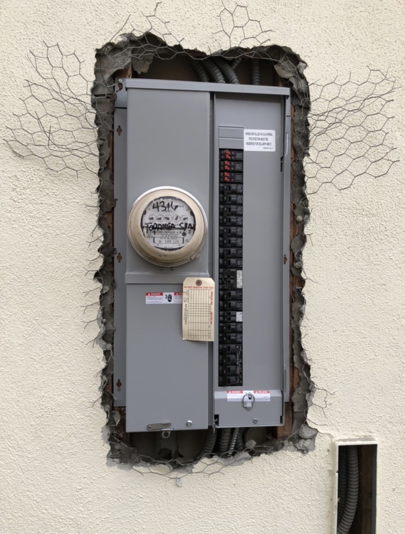 New meter main panel installed in an exterior stucco wall